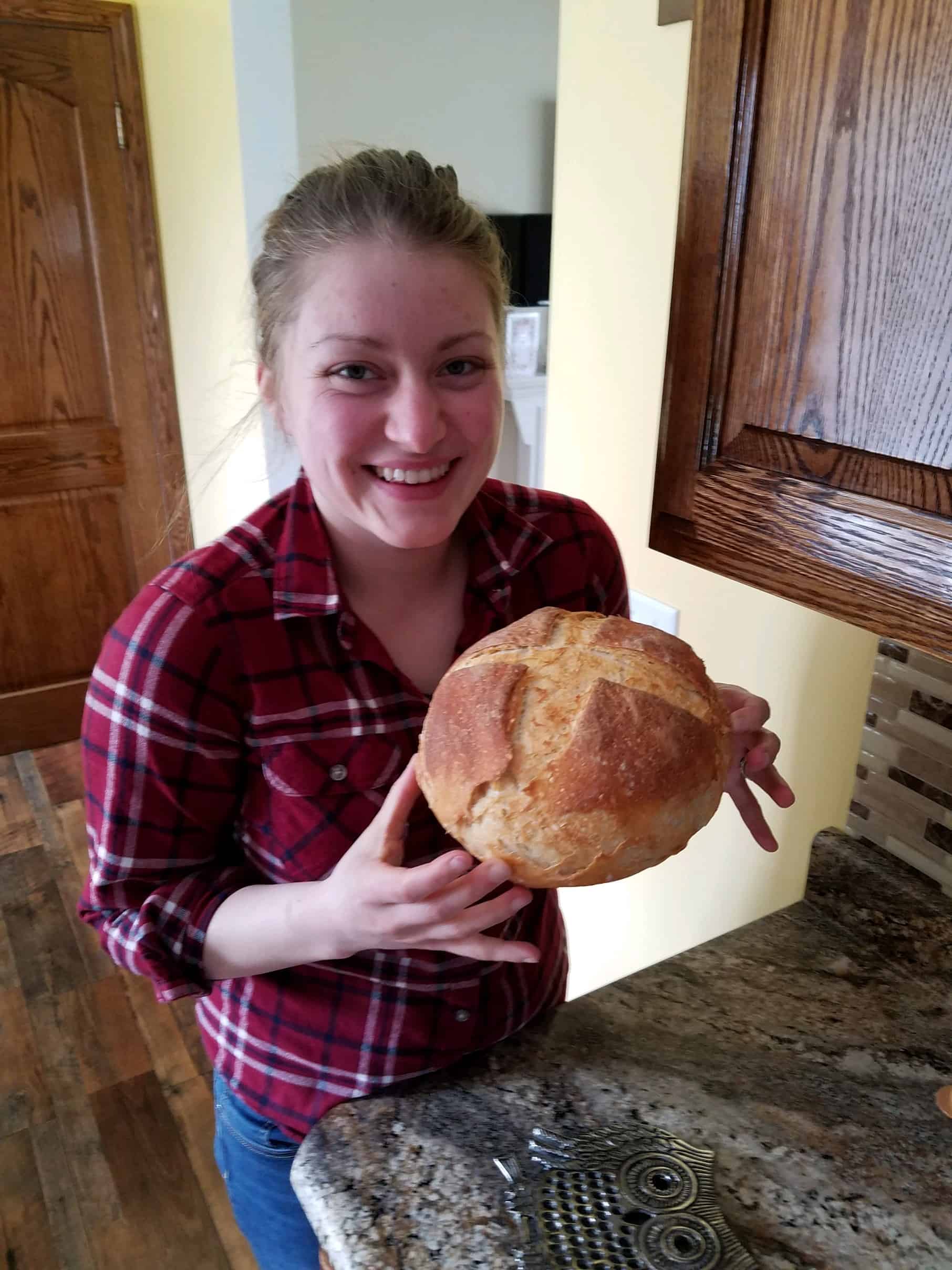 Snack Master Eliz holding a fresh, baked bread